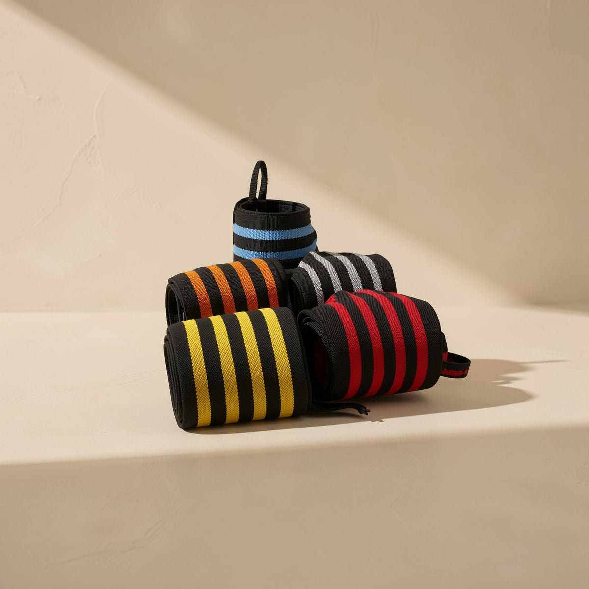Polyester wrap-around wrist straps described for weightlifting support and bodybuilding deadlifts